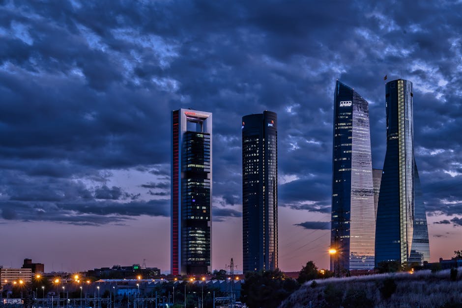A captivating view of Madrid's skyscrapers at night under a moody sky.
